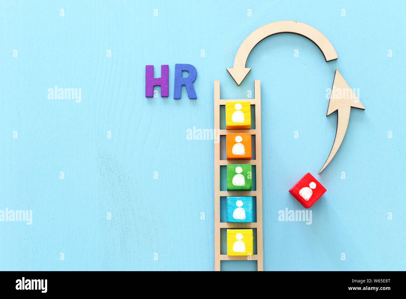 Business image of wooden ladder with people icons over blue table ...