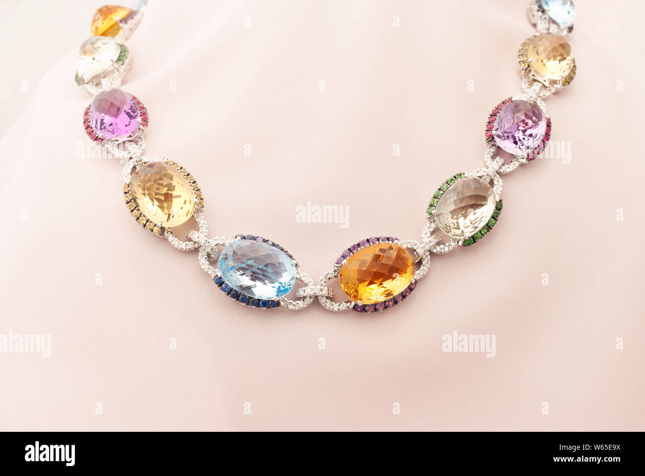 White Gold Necklace With Blue And Yellow Sapphire, Rubies, Amethyst, Green Garnet And Diamonds Stock Photo