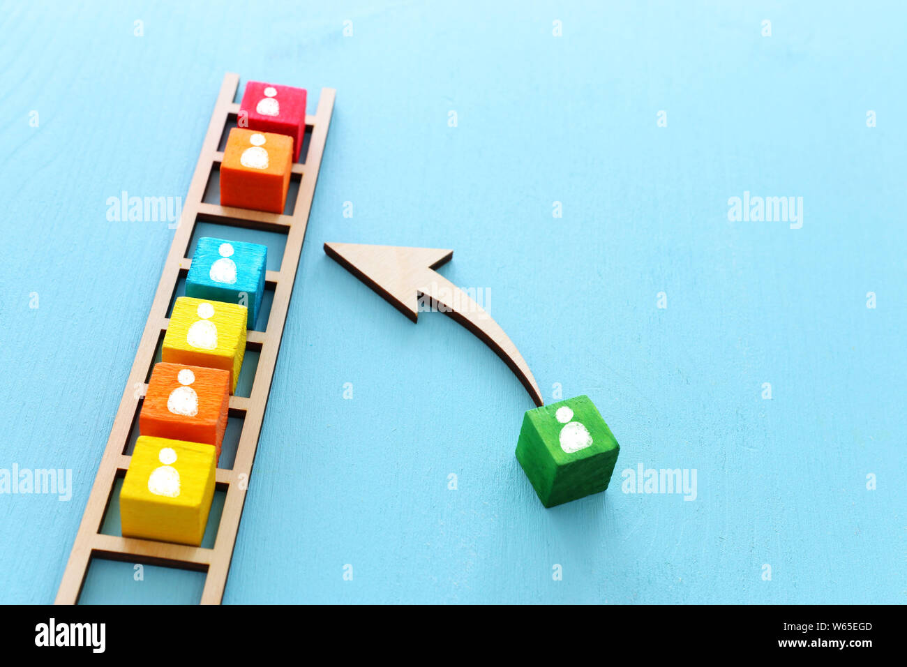 Business image of wooden ladder with people icons over blue table ...