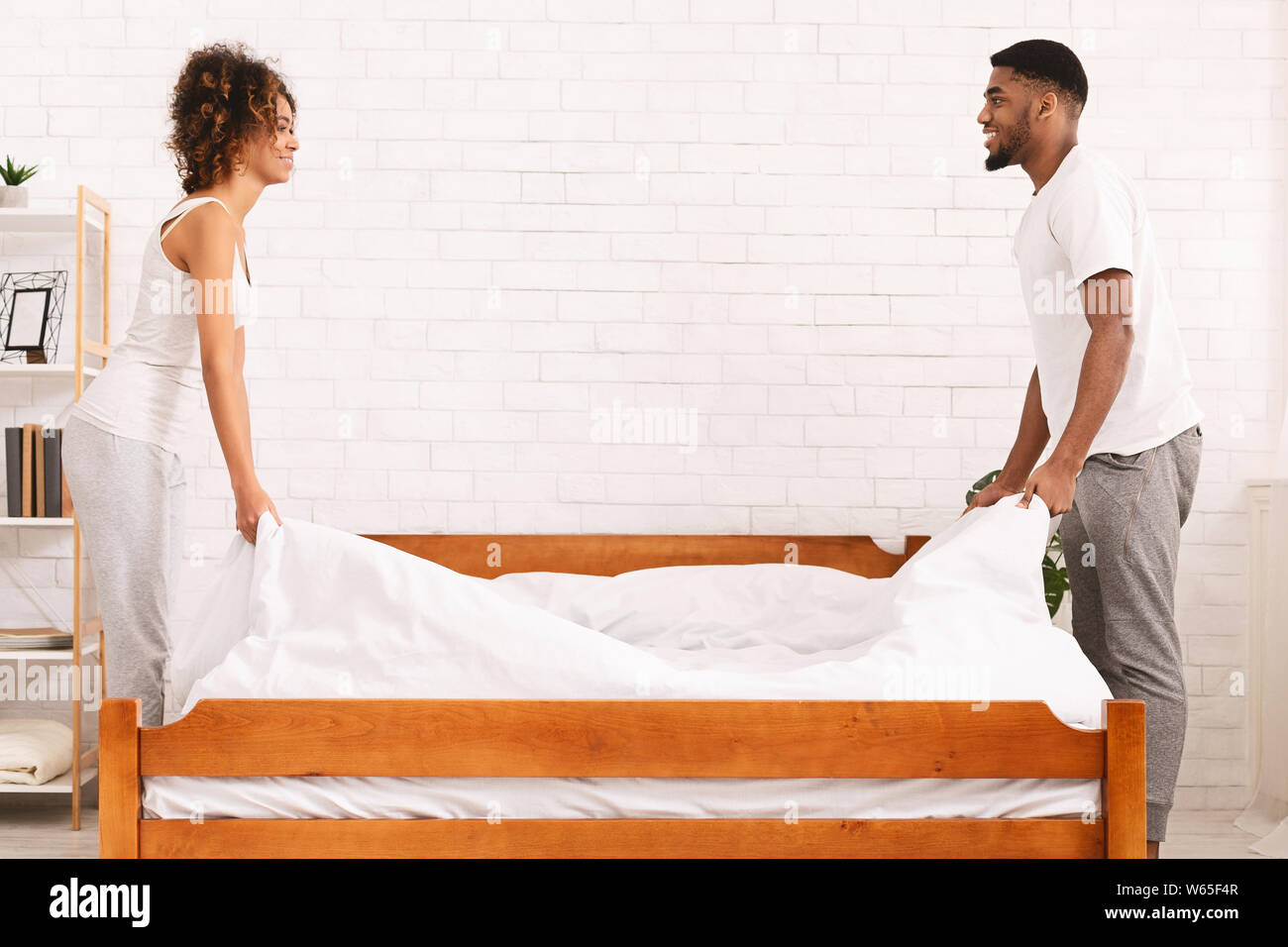 Charming Beautiful Couple In Love Making Bed Together Stock Photo