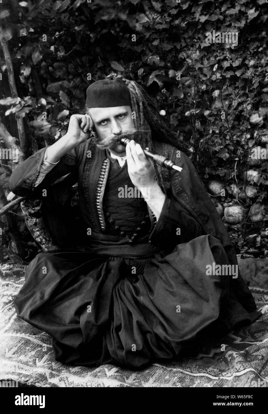 Albanian smokes a pipe in the Islamic era, 1900-10 Stock Photo