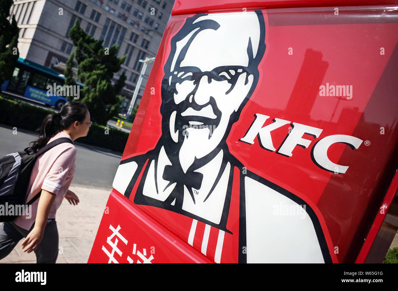 --FILE--A pedestrian walks past a logo of KFC of Yum Brands in Ji'nan city, east China's Shandong province, 28 August 2016.   The rejection of a US$17 Stock Photo