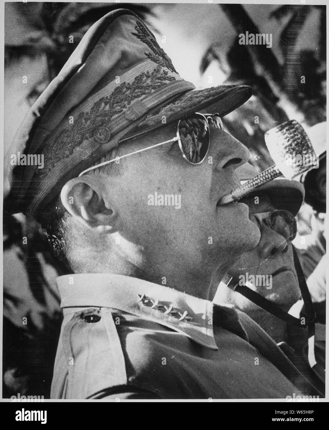 General MacArthur surveys the beachhead on Leyte Island, soon after American forces swept ashore from a gigantic liberation armada into the central Philippines, at the historic moment when the General made good his promise I shall return., 1944; General notes:  Use War and Conflict Number 744 when ordering a reproduction or requesting information about this image. Stock Photo