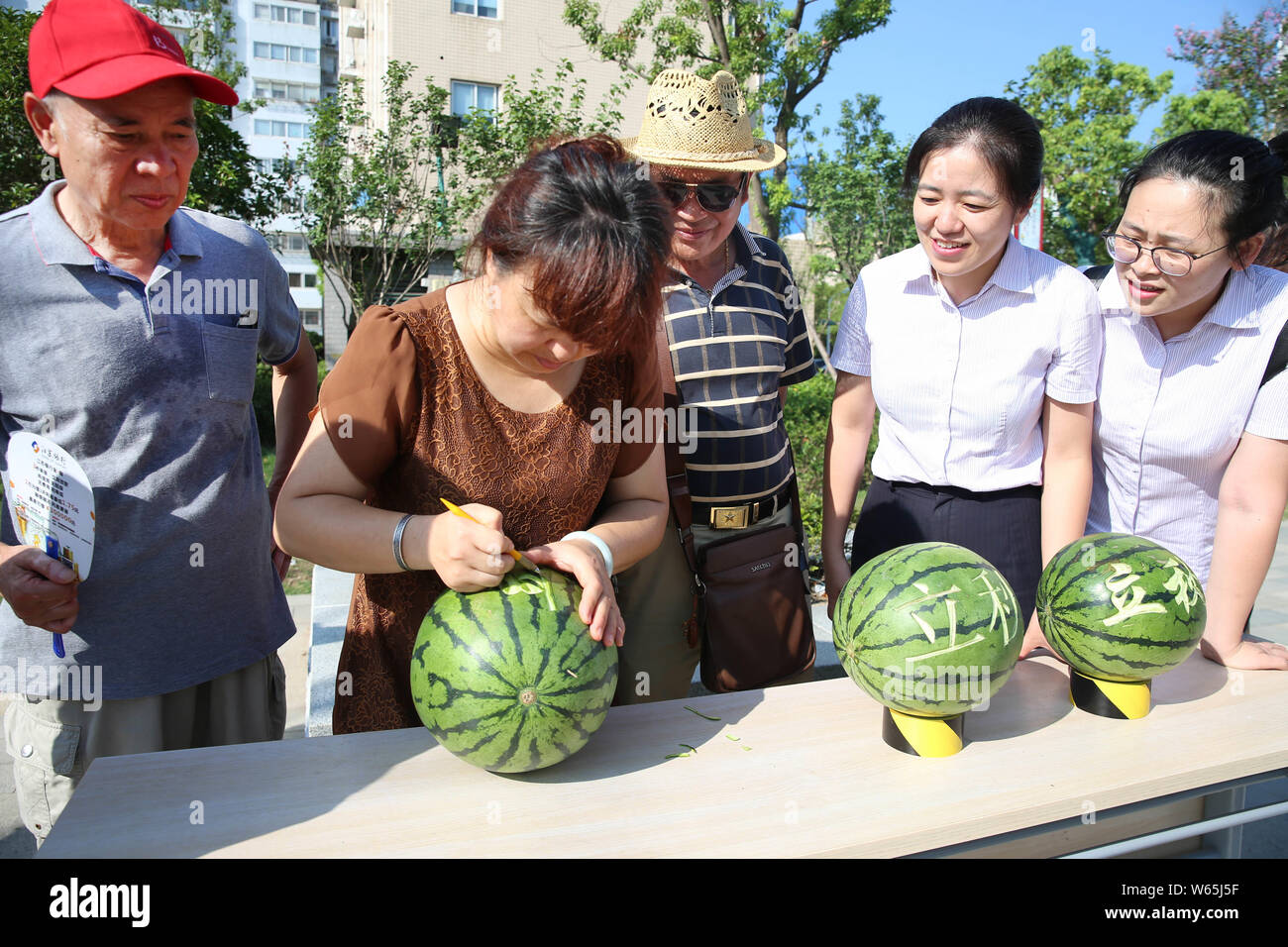 Chinese citizens take part in watermelon-themed games to mark Liqiu, meaning the start of autumn, one of the traditional 24 solar terms, at a resident Stock Photo