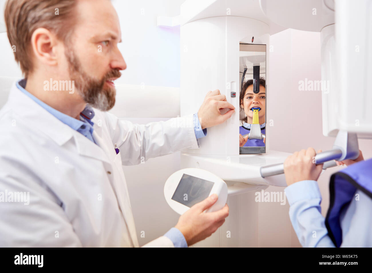 Dentist operates Xray device in radiology for diagnostics in the