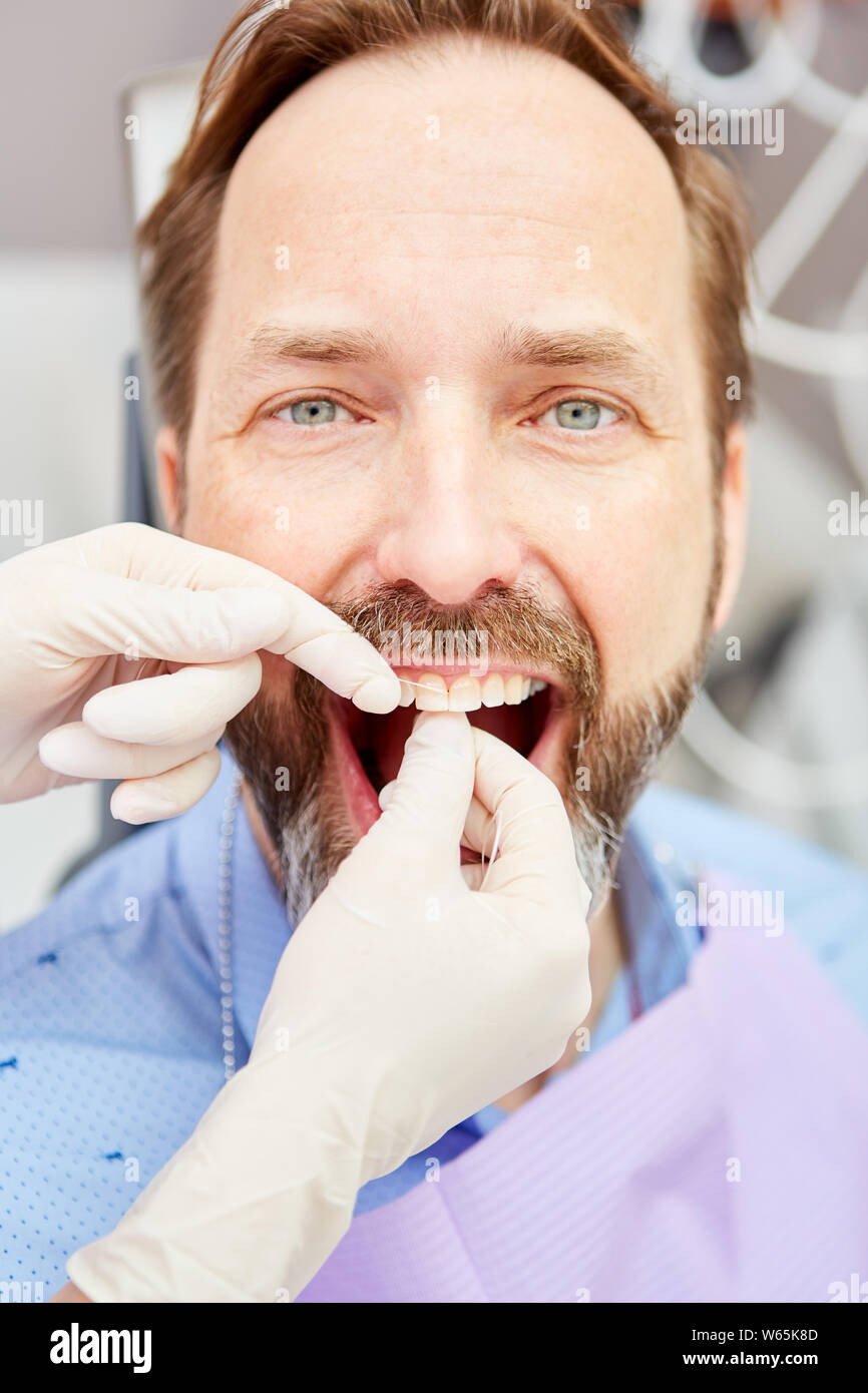 Patient is treated in the professional cleaning of teeth as a