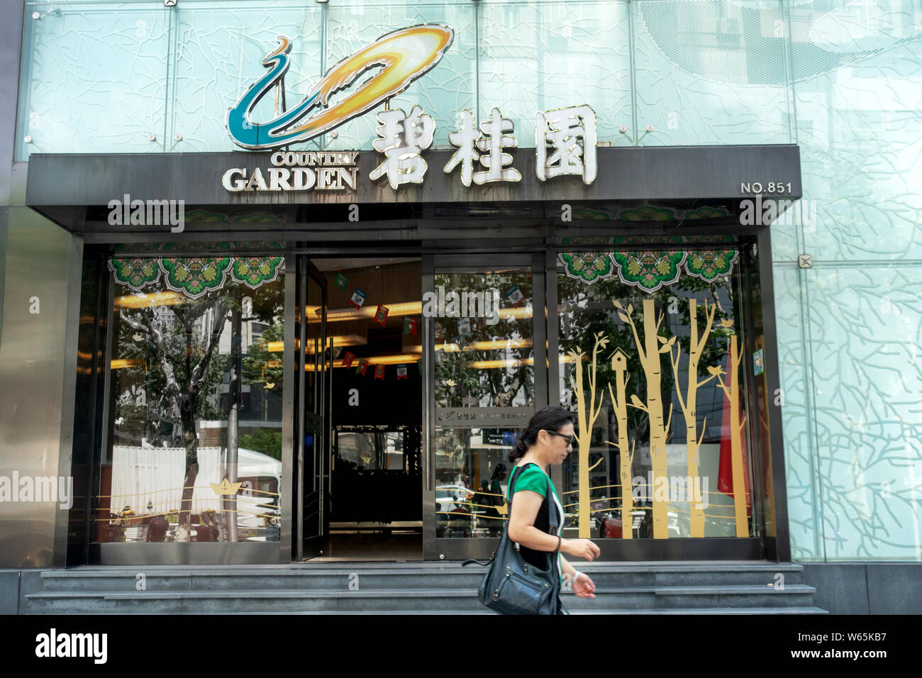 --FILE--A pedestrian walks past an exhibition hall of Chinese real ...