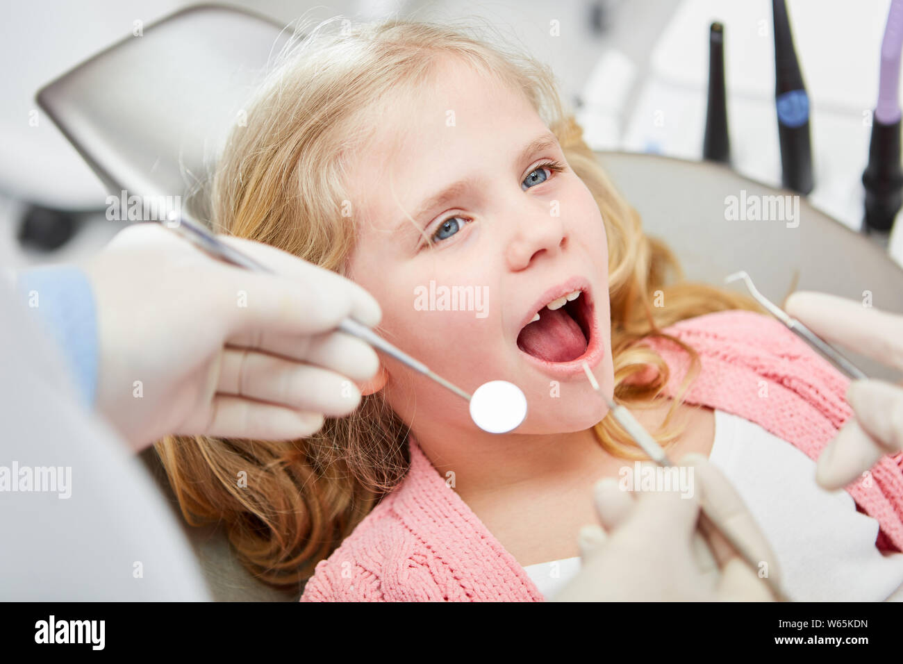 Girl with open mouth at dentist for precautionary examination Stock