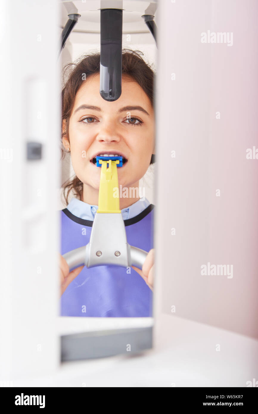 Young woman in the dentist's office as a patient with the Xray at the