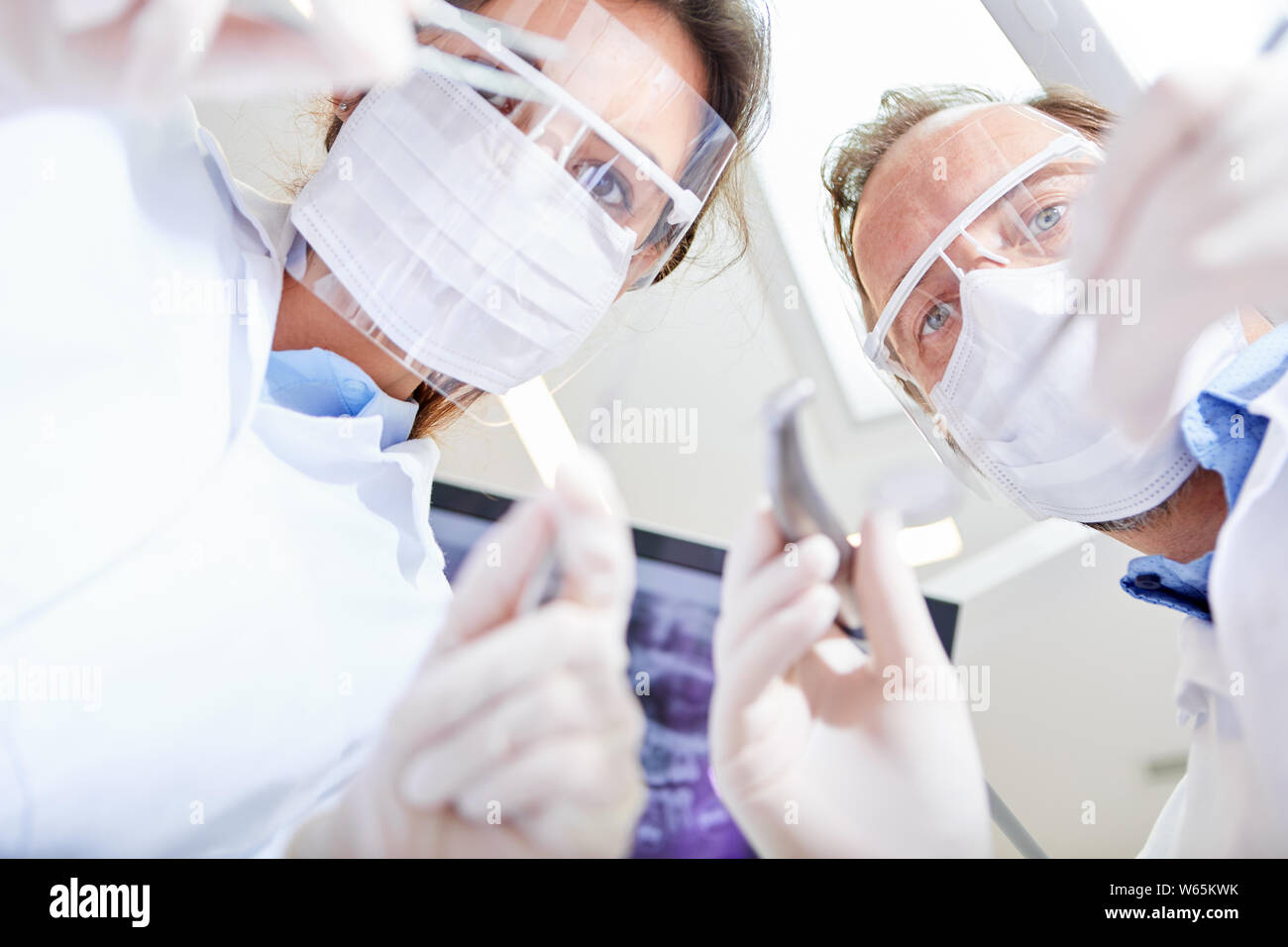 Two doctors as surgeons in an emergency operation in the oral surgery of a dental clinic Stock