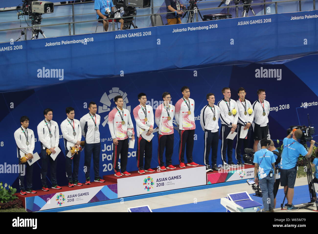 Swimmers of (From left) Japan, China, Kazakhstan stand on the podium at the award ceremony after the men's 4x100 medley relay swimming final during th Stock Photo