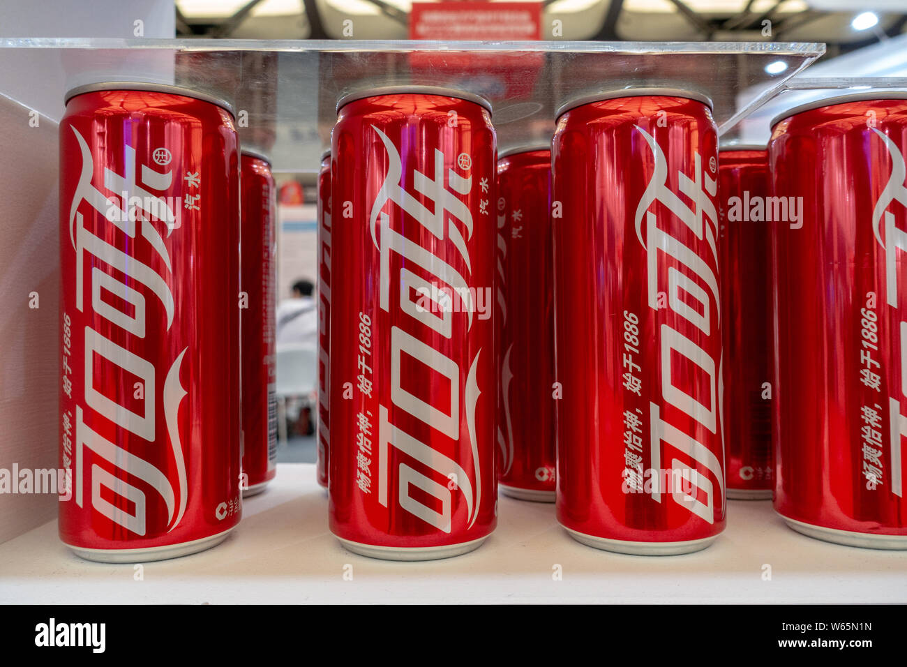 --FILE--Tins of Coca-Cola coke are displayed during an expo in Shanghai, China, 12 July 2018.   US soda and beer lovers might want to start stocking u Stock Photo