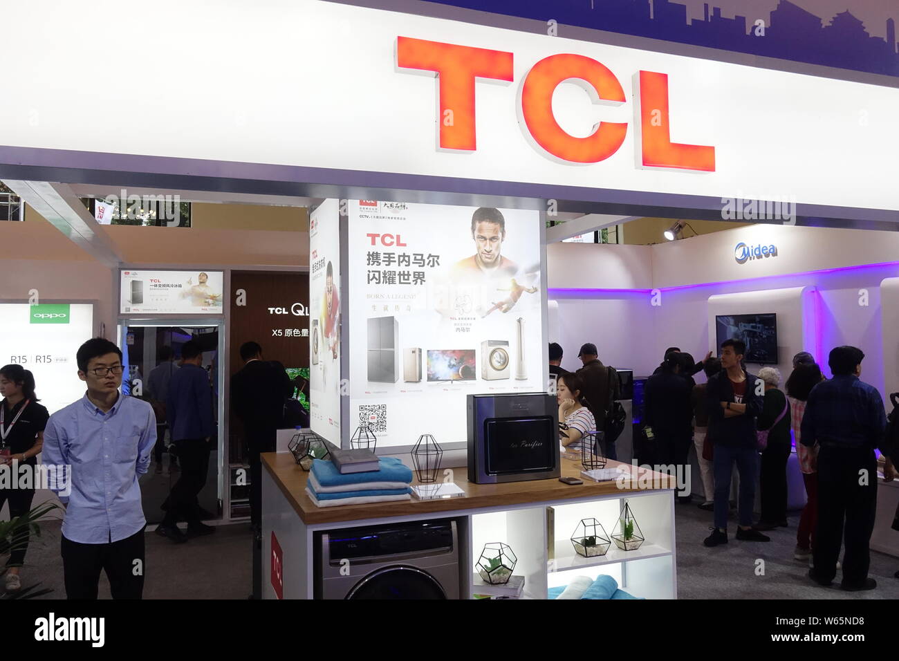 --FILE--People visit the stand of Chinese electronics giant TCL Corp during the 2018 International Consumer Electronics Show Asia (CES Asia 2018) in S Stock Photo