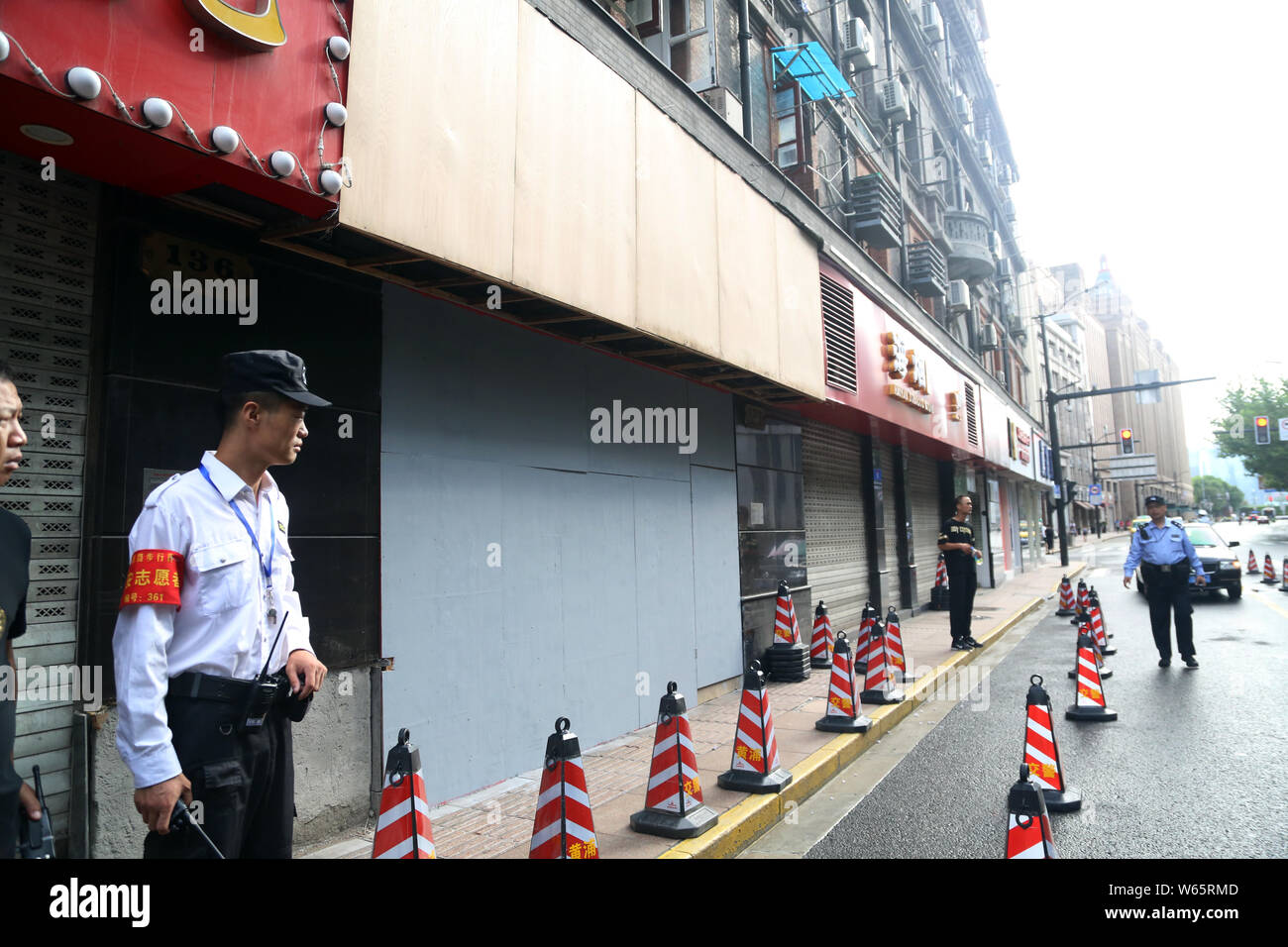 Security guards set up a cordoned-off area in front of the souvenir shop after its signboard collapsed, killing 3 people and injuring 6 others, on Eas Stock Photo