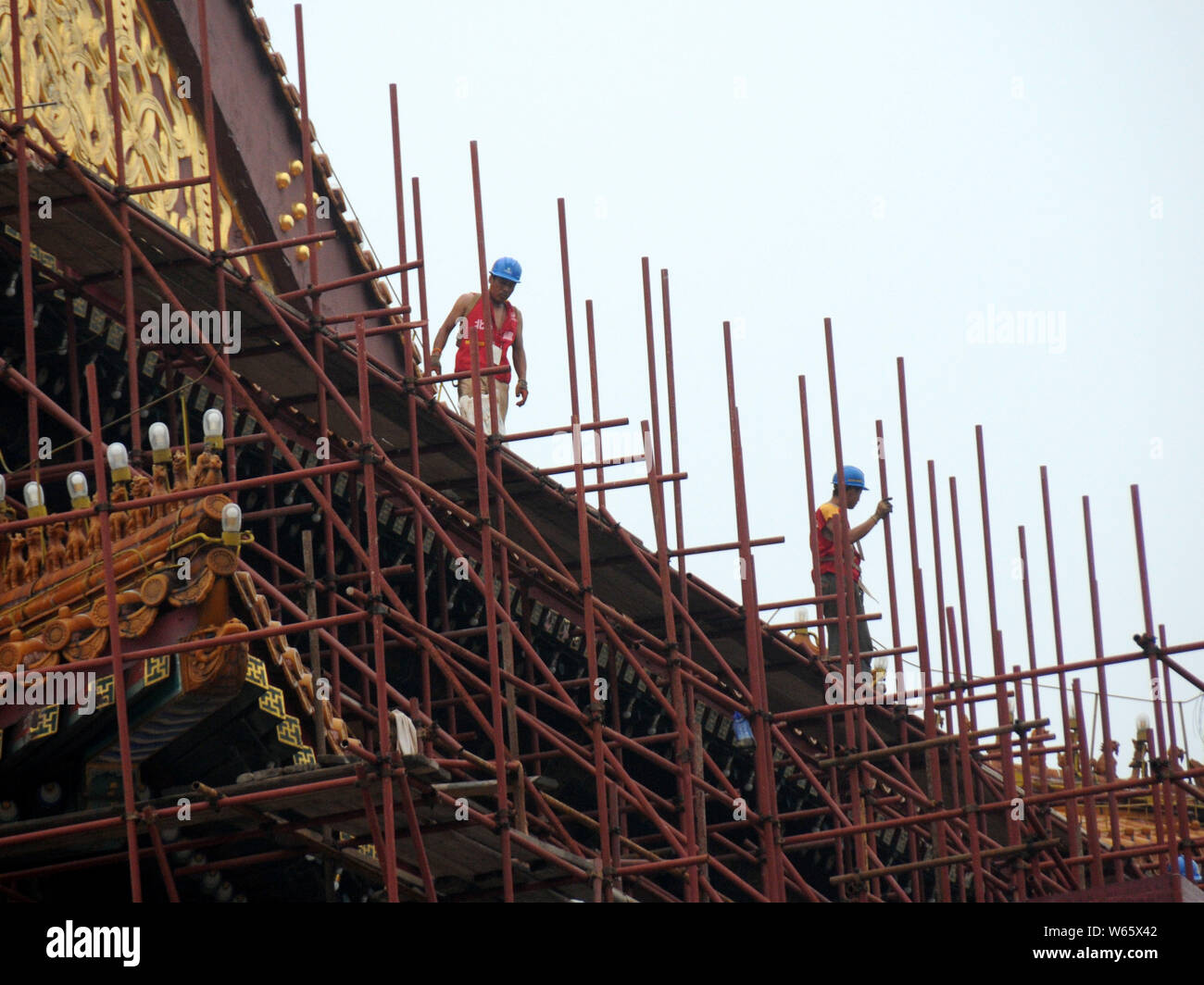 Chinese workers labor at the renovation site of the Tian'anmen Rostrum ...
