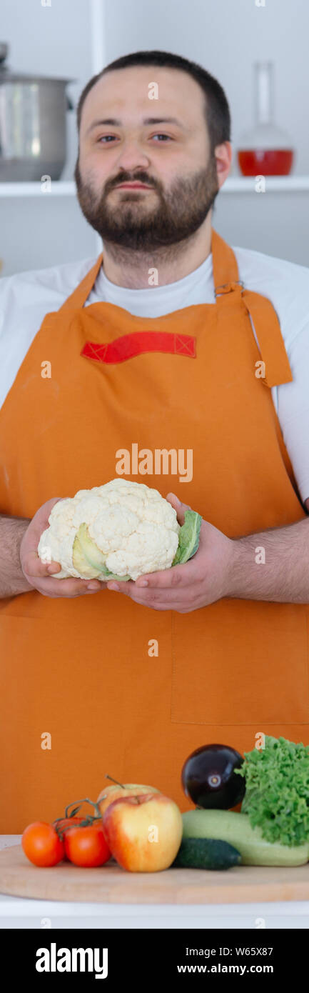 Handsome man holding cauliflower Stock Photo