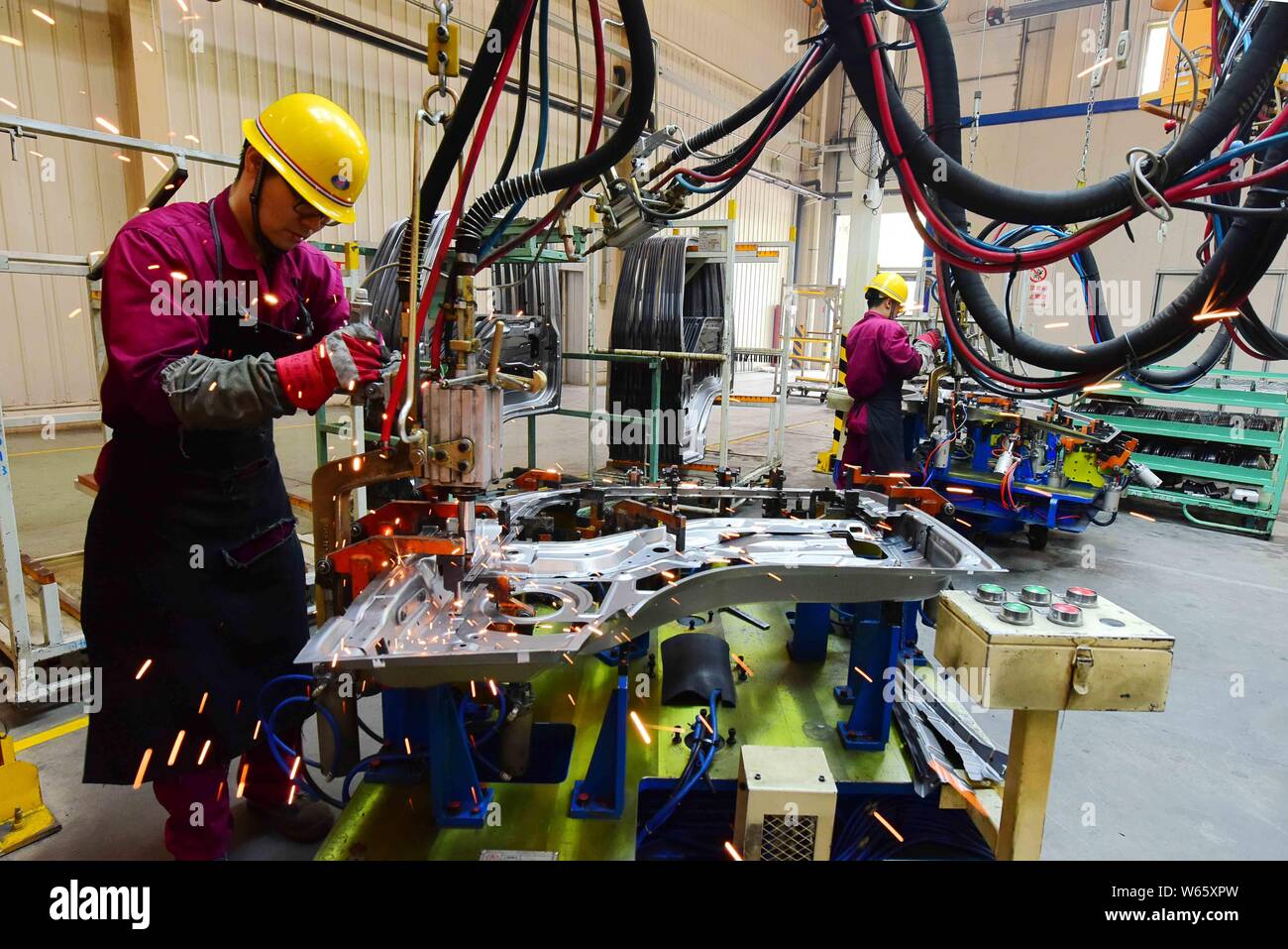 --FILE--Chinese workers assemble trucks on the assembly line at the ...