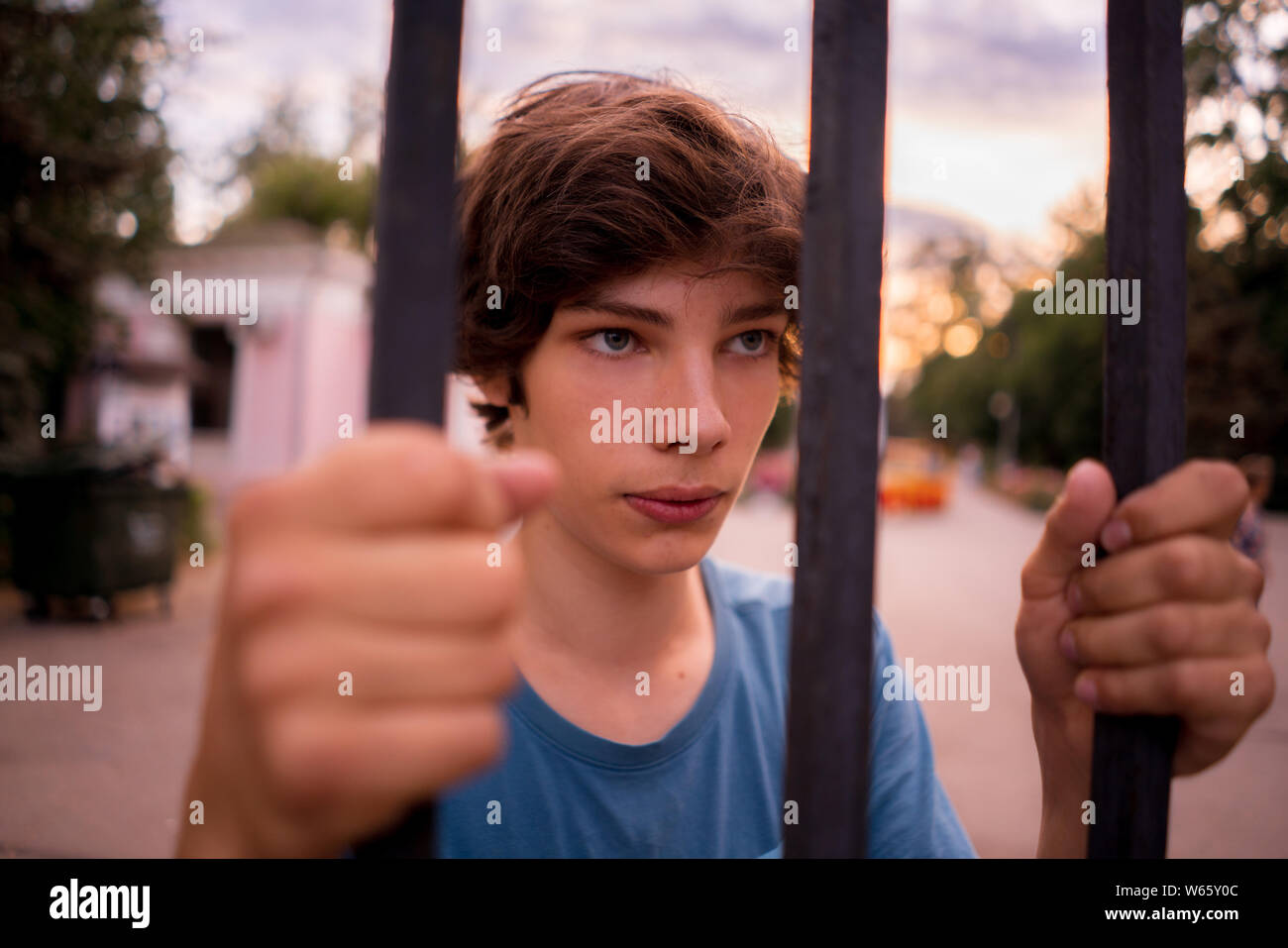 close up dispair man standing next to the cell looking at the city freedom life Stock Photo