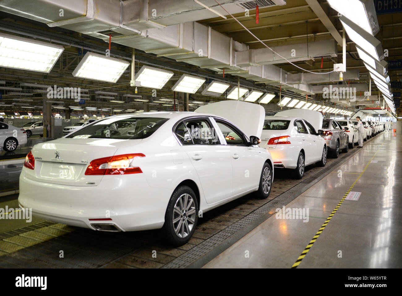 Chinese workers assemble Peugeot 508 on the assembly line at an auto ...