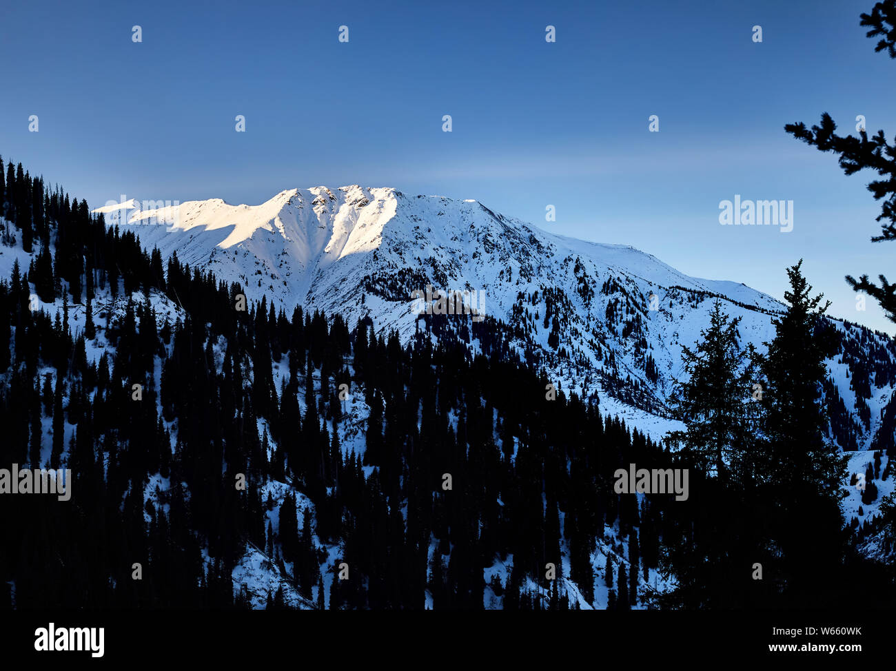 High snowy mountain Kumbel at Zaili Alatay range in Almaty, Kazakhstan Stock Photo