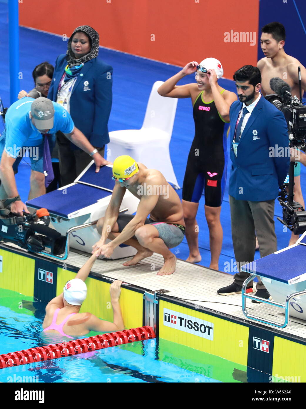 China's mixed 4x100 medley relay team celebrates after winning the