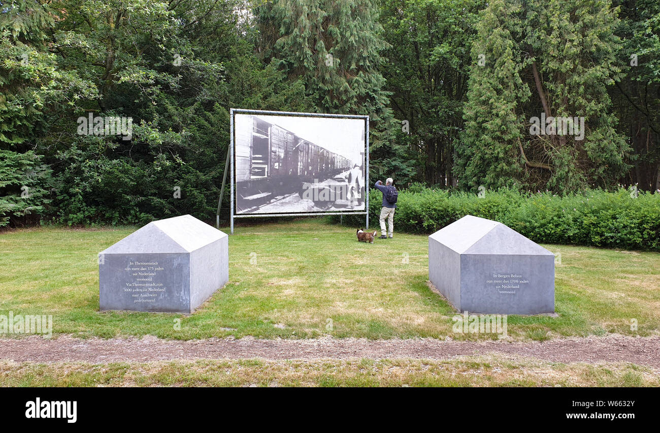 Westerbork, the Netherlands - July 2, 2019: A senior man and his Corgi dog are visiting the holocaust memorial site at concentration camp Westerbork. Stock Photo