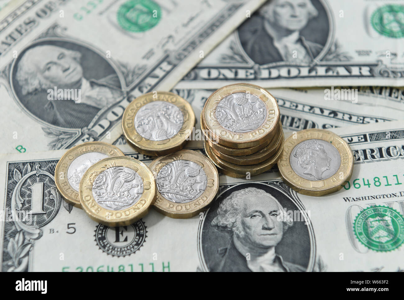 United States dollar bills and UK pound sterling coins. Stock Photo