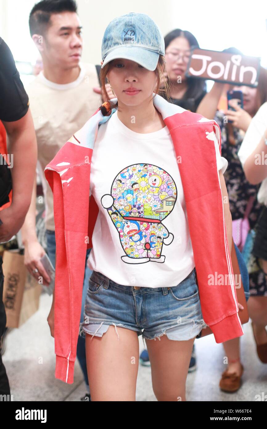 Taiwanese singer Jolin Tsai dressed in a Uniqlo Doraemon X Takashi Murakami  UT is pictured at the Beijing Capital International Airport in Beijing, Ch  Stock Photo - Alamy