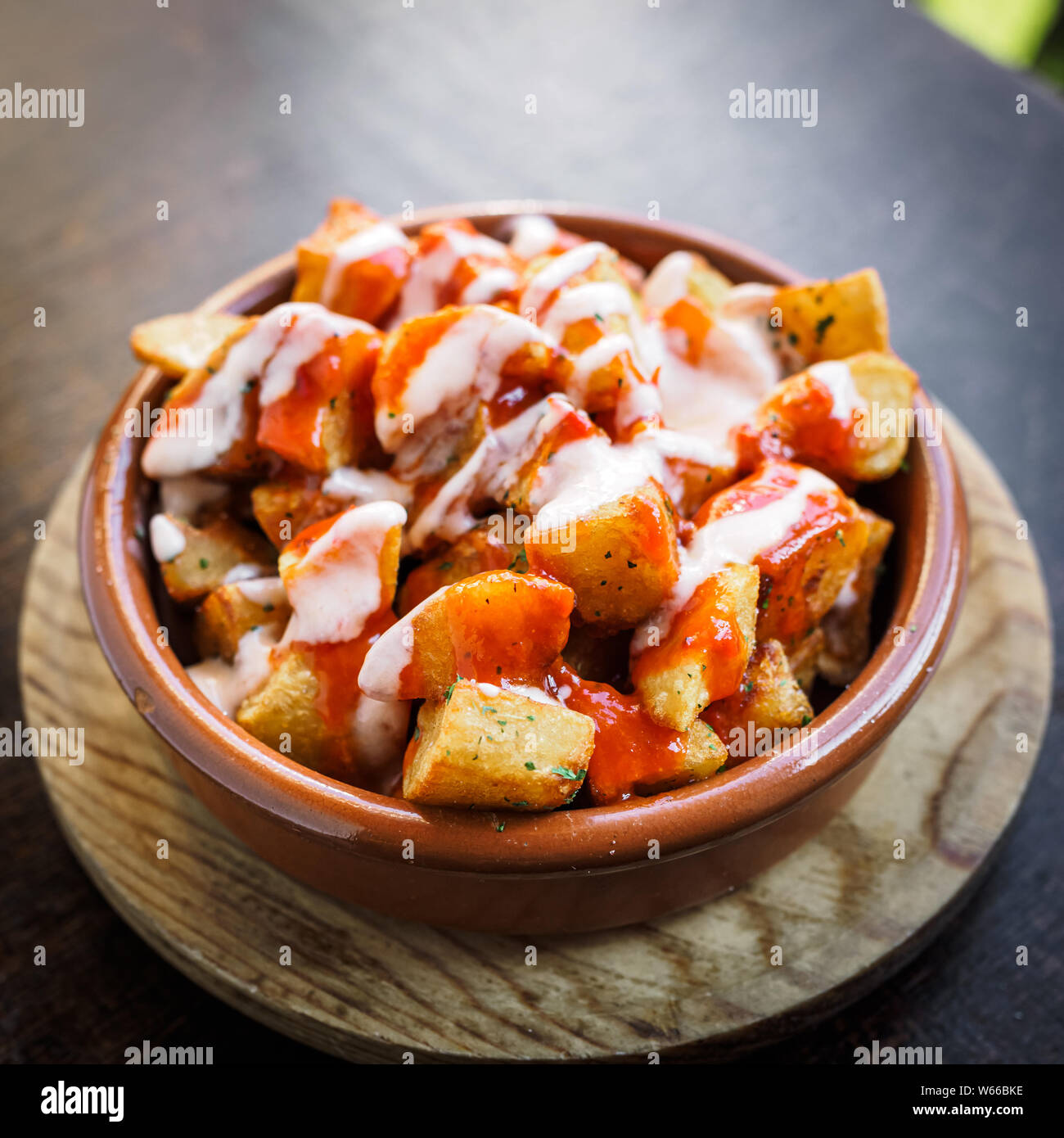 Spanish potatoes patatas bravas for tapas with tomato and spicy sauce on a bowl Stock Photo