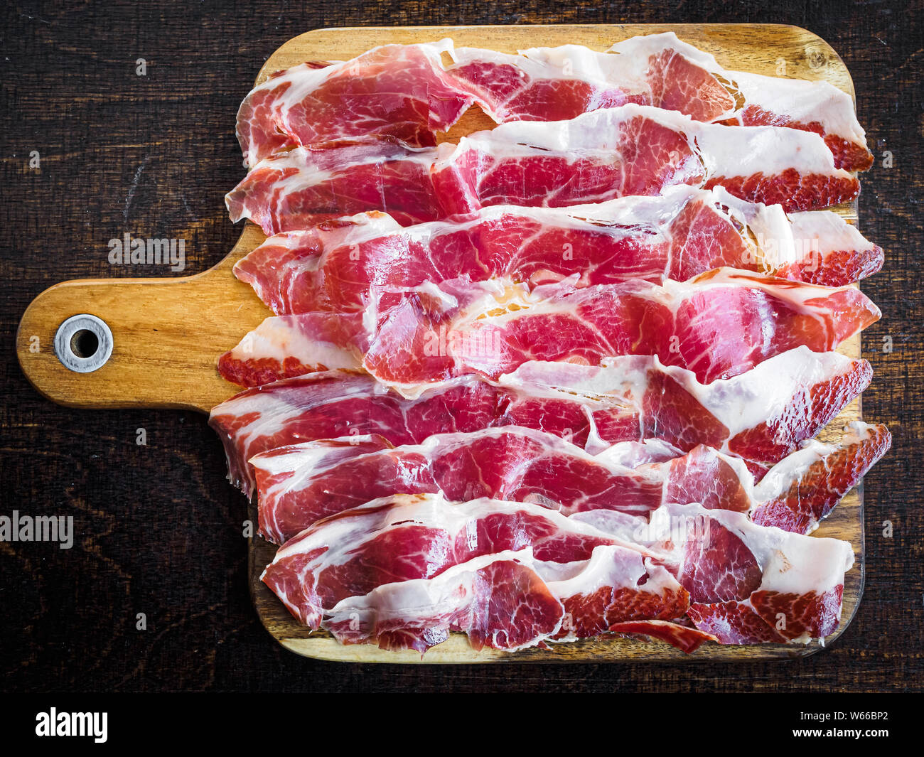 Iberico ham cut on a wooden board, spanish typical tapa Stock ...