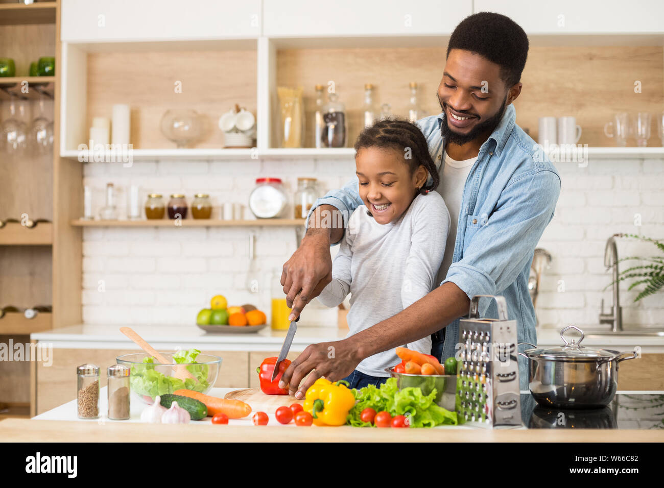 Dad teaching his daughter to cook salad Stock Photo - Alamy