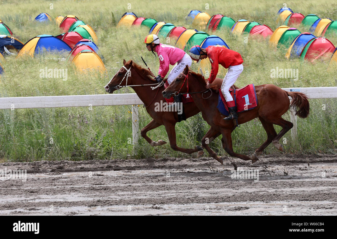 Participants compete in a horse racing in Zhaosu county, Ili Kazakh Autonomous Prefecture, northwest China's Xinjiang Uyghur Autonomous Region, 17 Jul Stock Photo