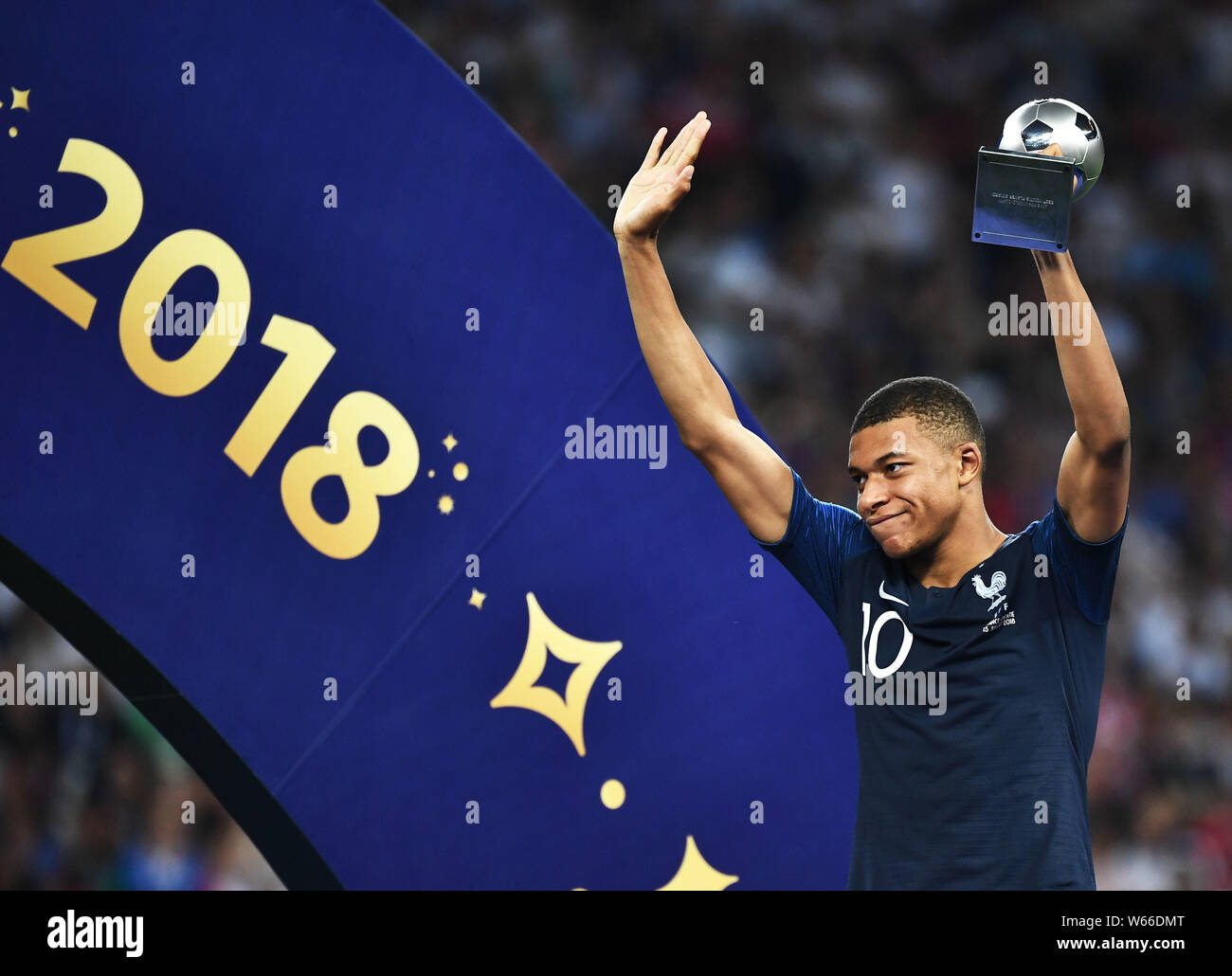 Kylian Mbappe of France poses with the trophy after France defeated Croatia in their final match during the 2018 FIFA World Cup in Moscow, Russia, 15 Stock Photo