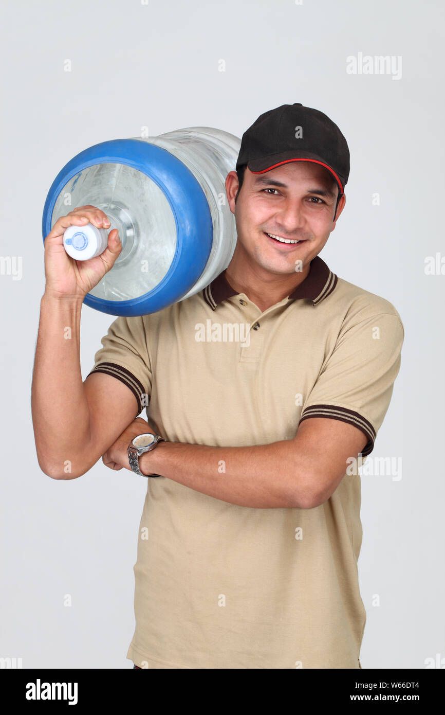 Delivery man carrying water bottle Stock Photo Alamy