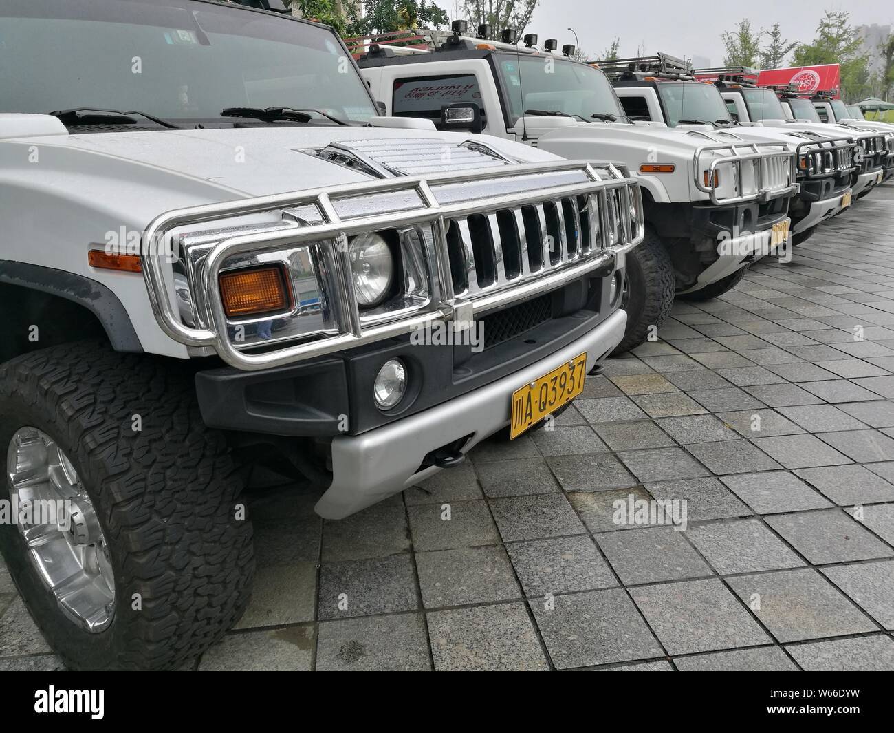 Extended edition Hummer SUVs are lined up in front of an exhibition ...