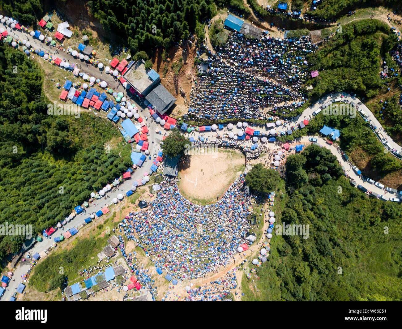 An aerial view of visitors and local people of Miao and Dong ethnical minorities watching a bullfight to mark Liu Yue Liu, or the sixth day of the six Stock Photo