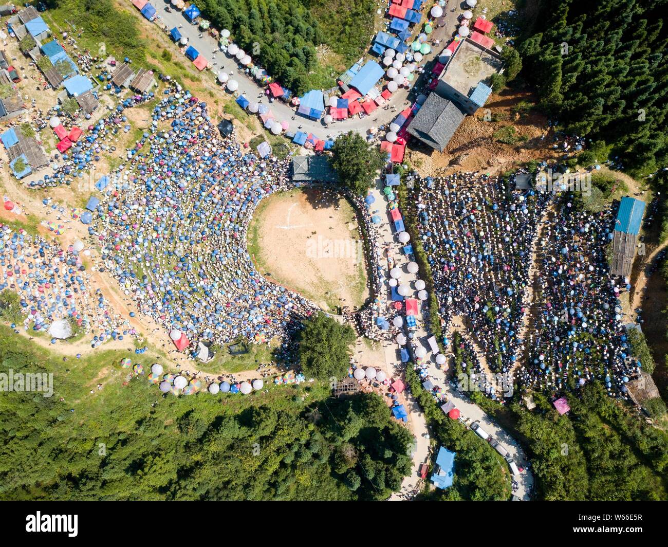 An aerial view of visitors and local people of Miao and Dong ethnical minorities watching a bullfight to mark Liu Yue Liu, or the sixth day of the six Stock Photo