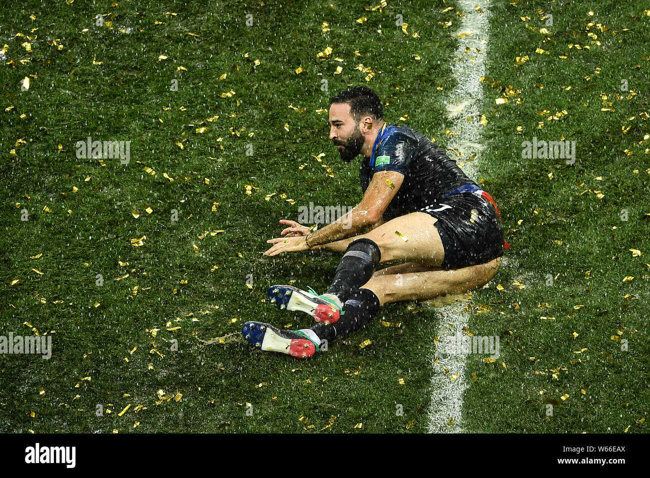 Adil Rami of France slides on the lawn to celebrate after France defeated Croatia in their final match during the 2018 FIFA World Cup in Moscow, Russi Stock Photo