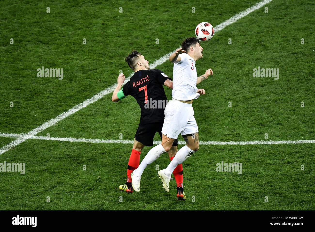 Luka Modric of Croatia, left, challenges John Stones of England in the extra time of their semifinal match during the 2018 FIFA World Cup in Moscow, R Stock Photo