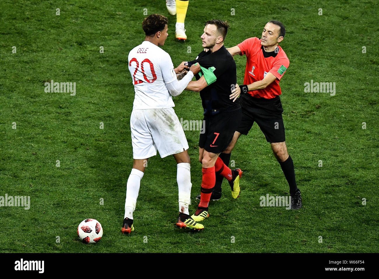 Dele Alli of England, left, conflicts with Ivan Rakitic of Croatia in the extra time of their semifinal match during the 2018 FIFA World Cup in Moscow Stock Photo
