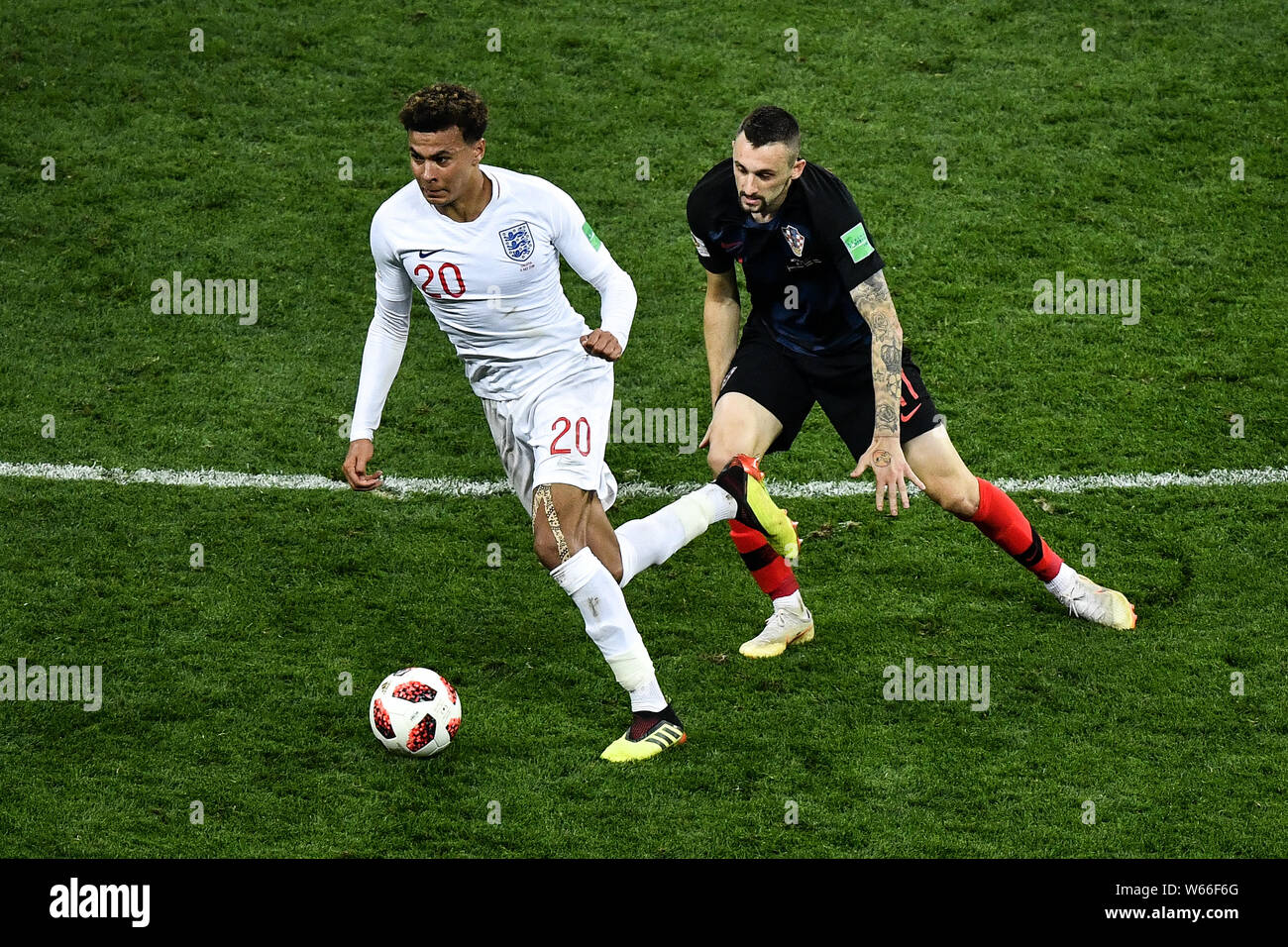 Dele Alli of England, left, challenges Marcelo Brozovic of Croatia in their semifinal match during the 2018 FIFA World Cup in Moscow, Russia, 11 July Stock Photo