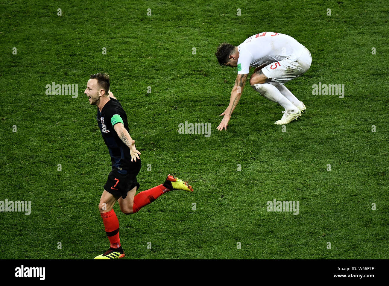 Ivan Rakitic of Croatia celebrates as he runs by John Stones of England after Croatia defeated England in their semifinal match during the 2018 FIFA W Stock Photo