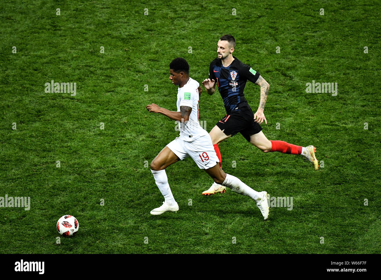 Marcus Rashford of England, front, challenges Marcelo Brozovic of Croatia in their semifinal match during the 2018 FIFA World Cup in Moscow, Russia, 1 Stock Photo