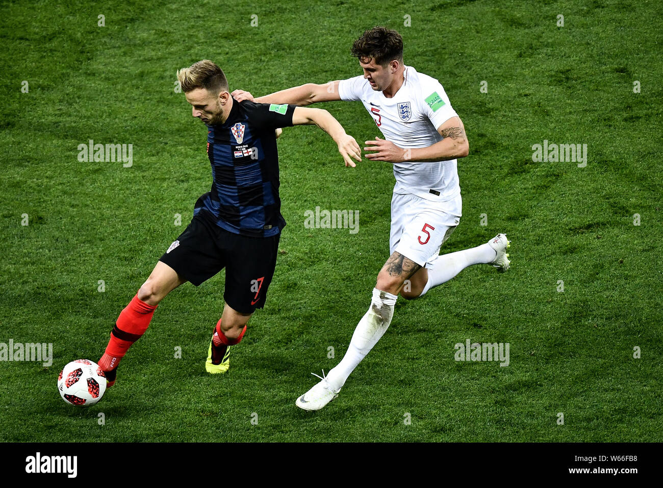 Ivan Rakitic of Croatia, left, challenges John Stones of England in their semifinal match during the 2018 FIFA World Cup in Moscow, Russia, 11 July 20 Stock Photo
