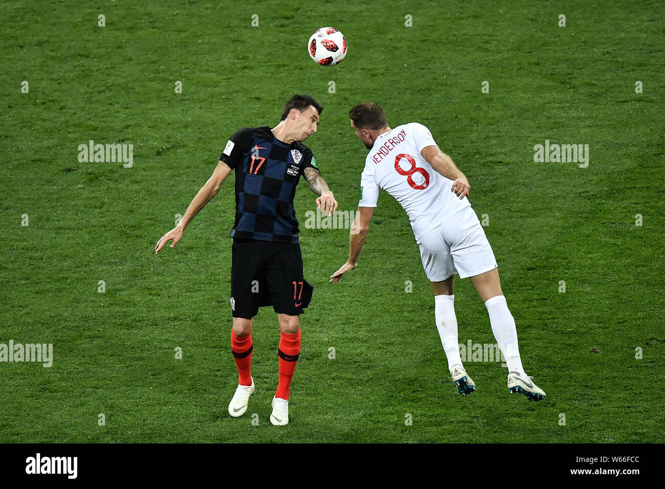 Jordan Henderson of England, right, challenges Mario Mandzukic of Croatia in their semifinal match during the 2018 FIFA World Cup in Moscow, Russia, 1 Stock Photo