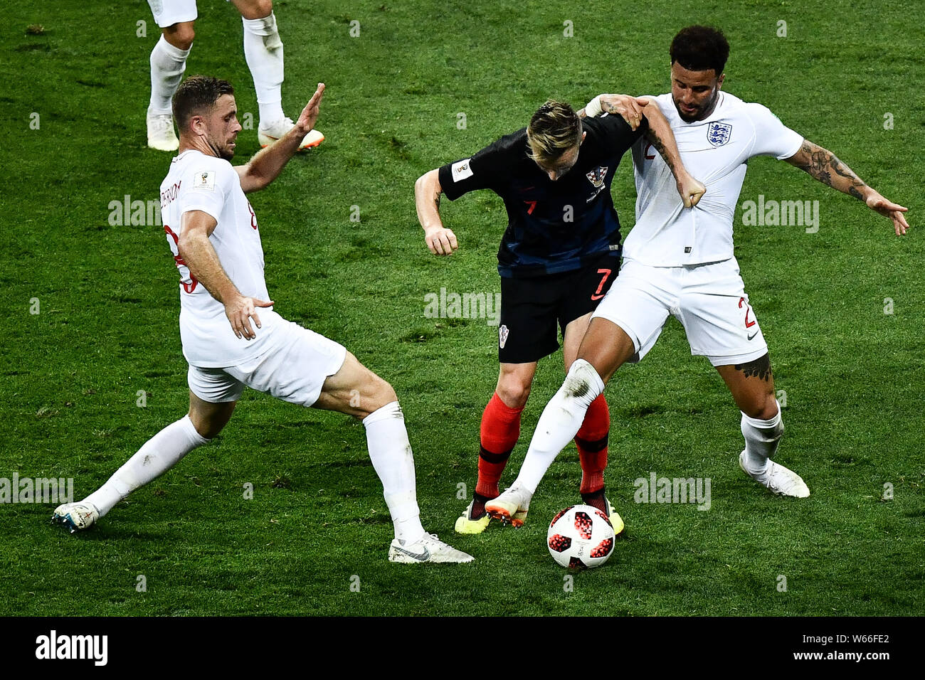 Ivan Rakitic of Croatia, center, challenges Kyle Walker, right, and Jordan Henderson of England in their semifinal match during the 2018 FIFA World Cu Stock Photo