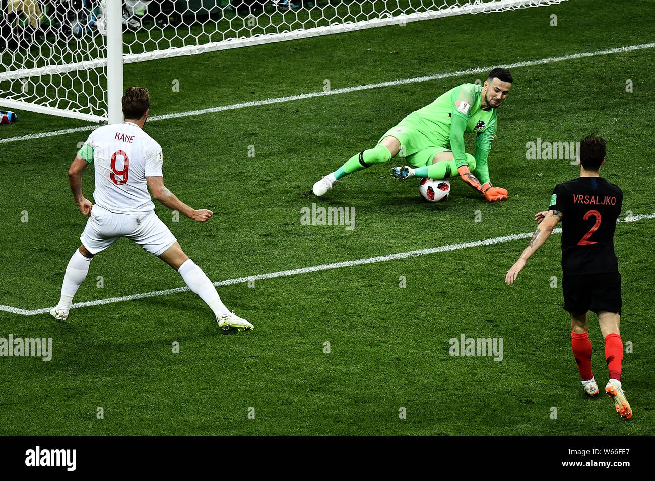 Goalkeeper Danijel Subasic of Croatia, back, tries to save a shot by Harry Kane of England, left, in their semifinal match during the 2018 FIFA World Stock Photo