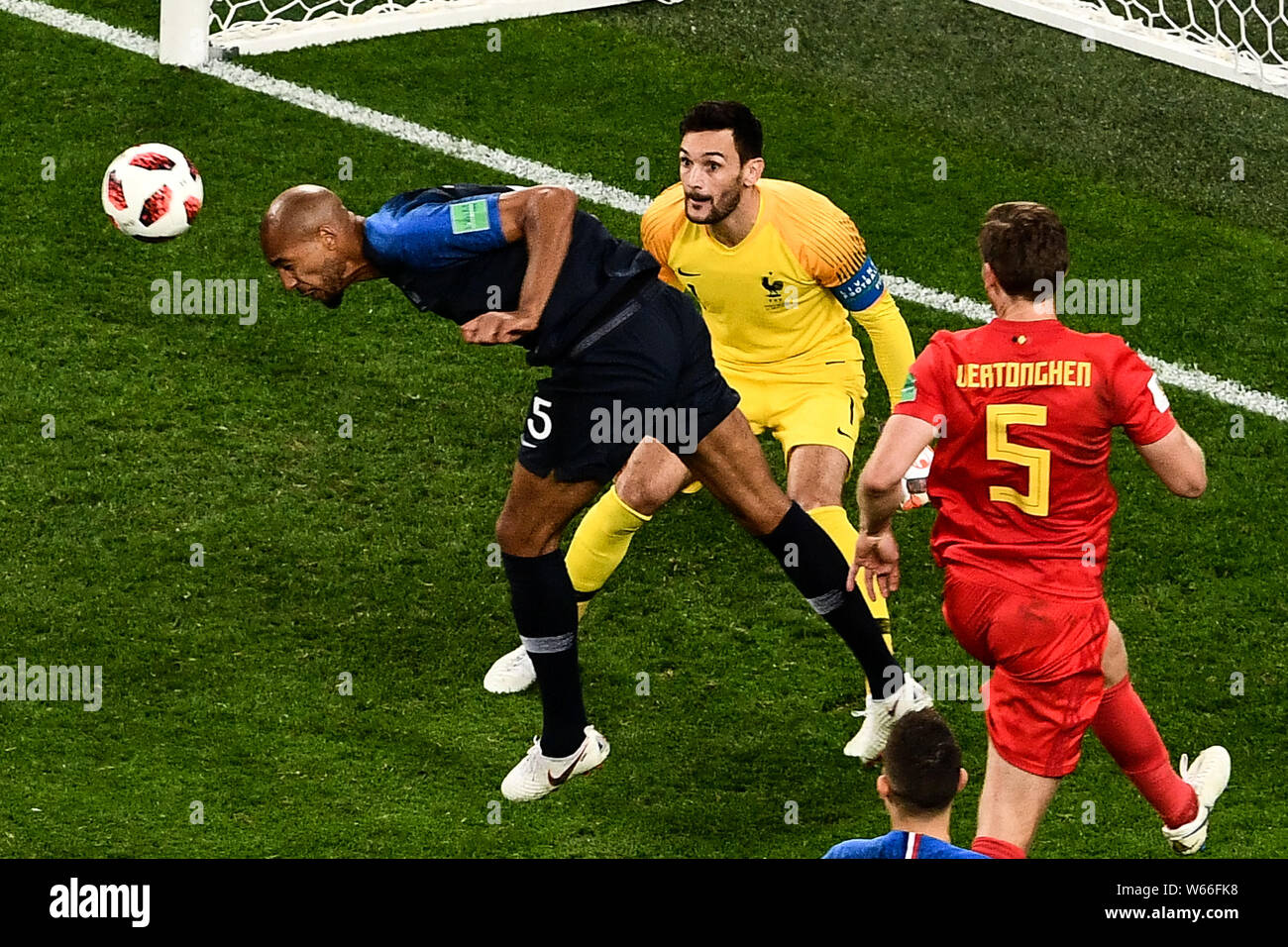 Steven Nzonzi of France strives for a header next to goalkeeper Hugo Lloris of France and Jan Vertonghen of Belgium in their semifinal match during th Stock Photo