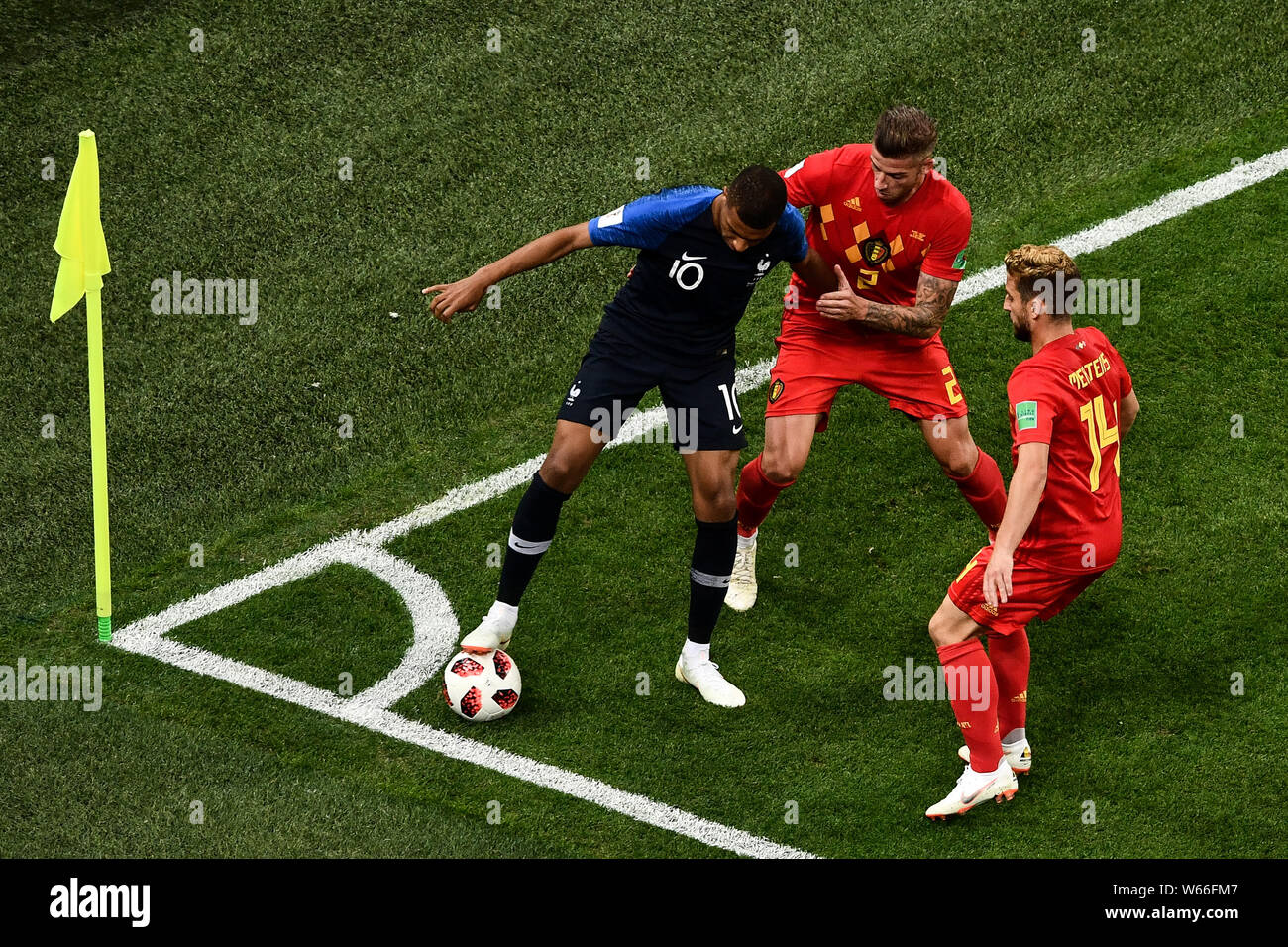 Kylian Mbappe of France, left, challenges Toby Alderweireld, center, and Dries Mertens of Belgium in their semifinal match during the 2018 FIFA World Stock Photo