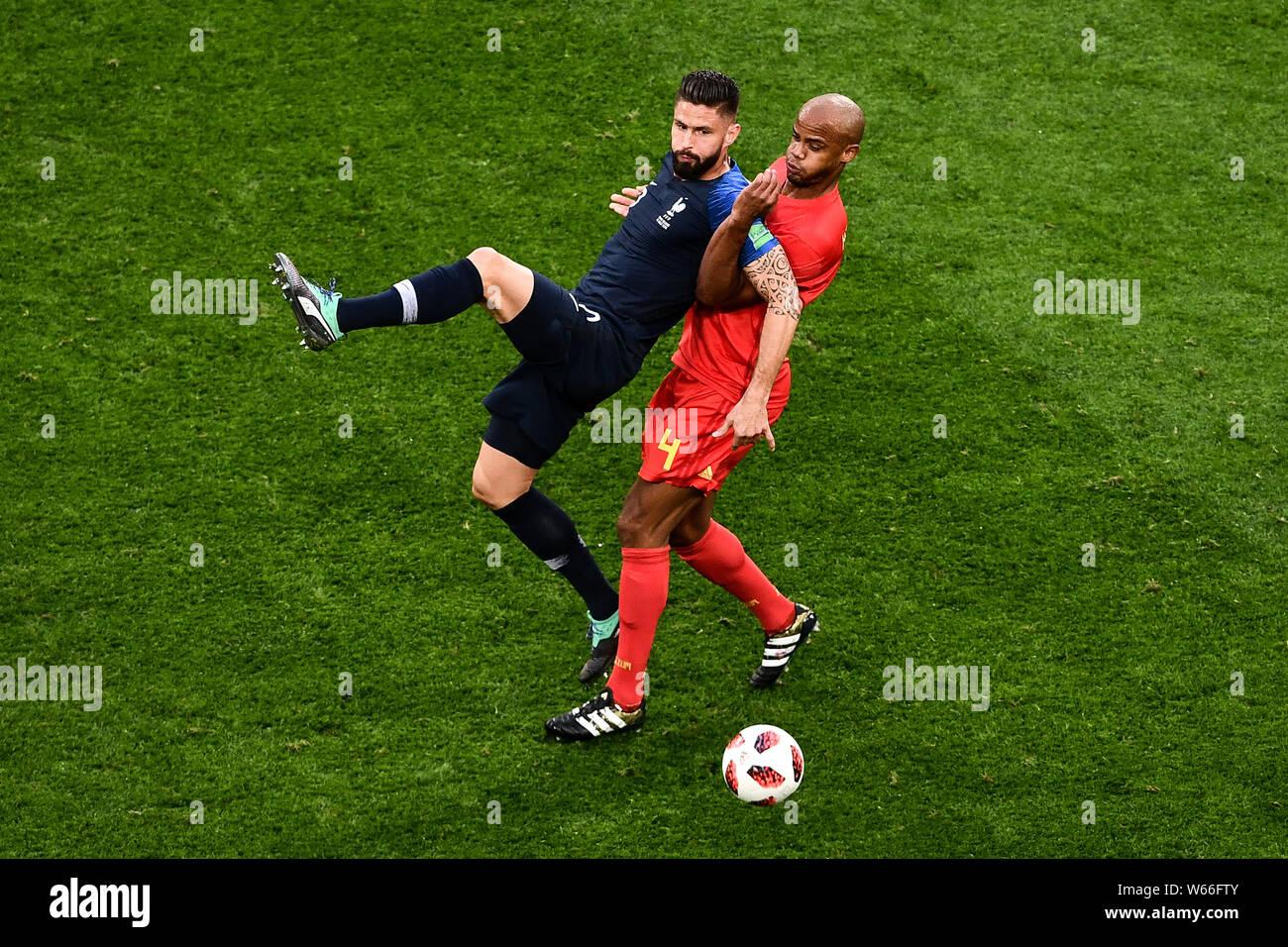 Vincent Kompany of Belgium, right, challenges Olivier Giroud of France in their semifinal match during the 2018 FIFA World Cup in Saint Petersburg, Ru Stock Photo